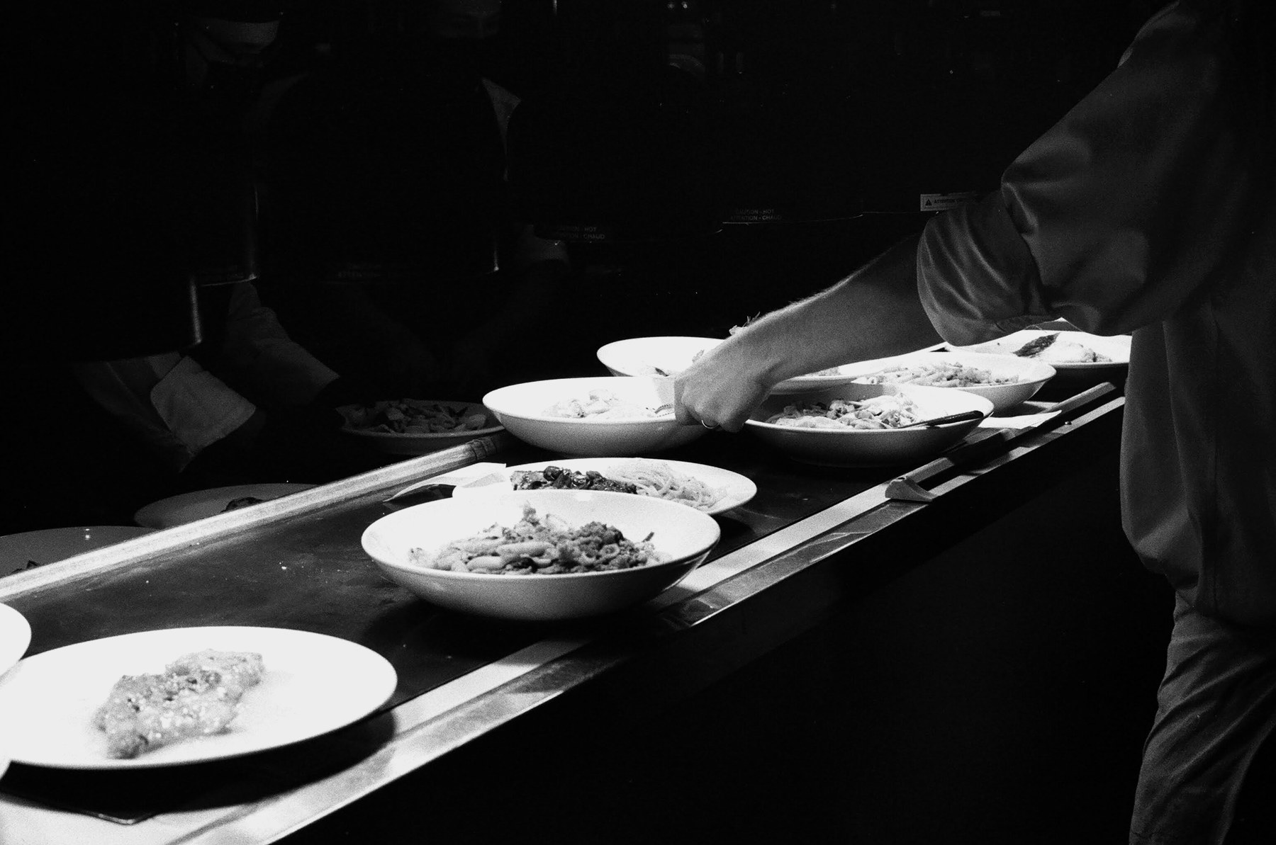 Chef executing foodservice presentation in a professional kitchen